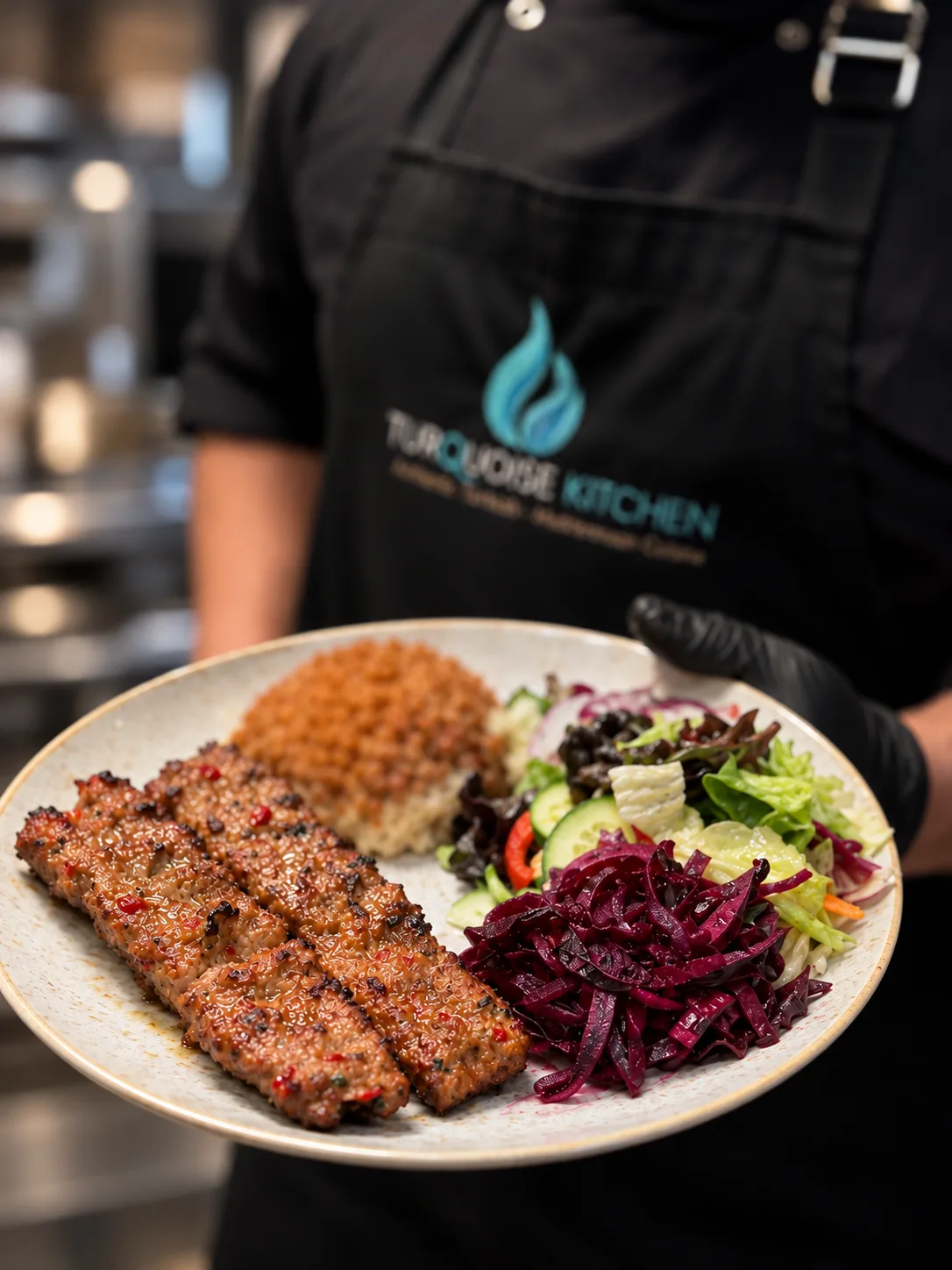 Adana kebab with bulgur and salad
